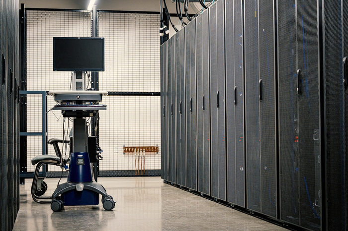 A portable desktop in the middle of a server room.